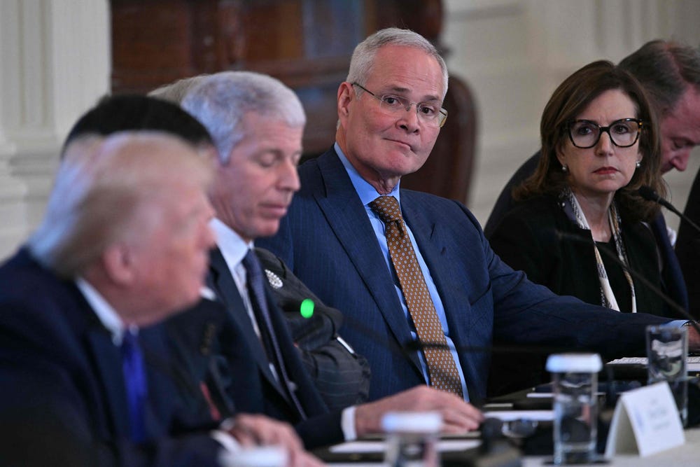 ExxonMobil chief executive Darren Woods (centre) attends a meeting with US President Donald Trump (left) and oil company executives in the East Room of the White House in Washington, DC on 9 January 2026.